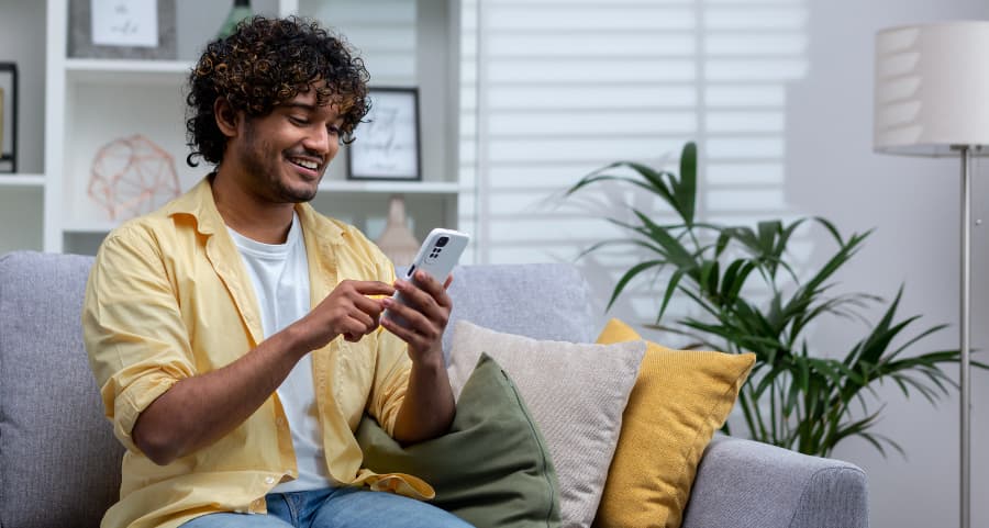 Resident using a home security app on his smartphone